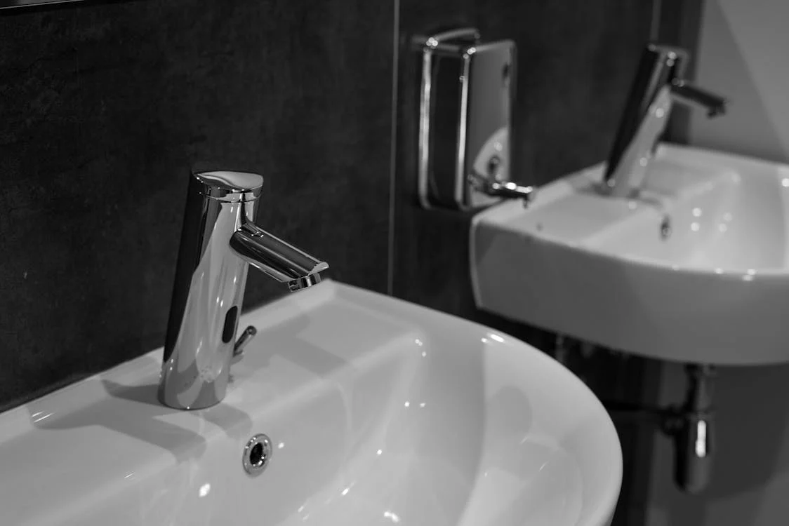 Two white ceramic bathroom sinks