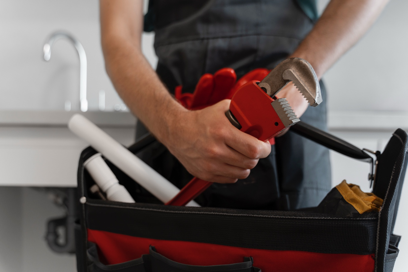 A plumber with tools responding to an emergency call in Brockton