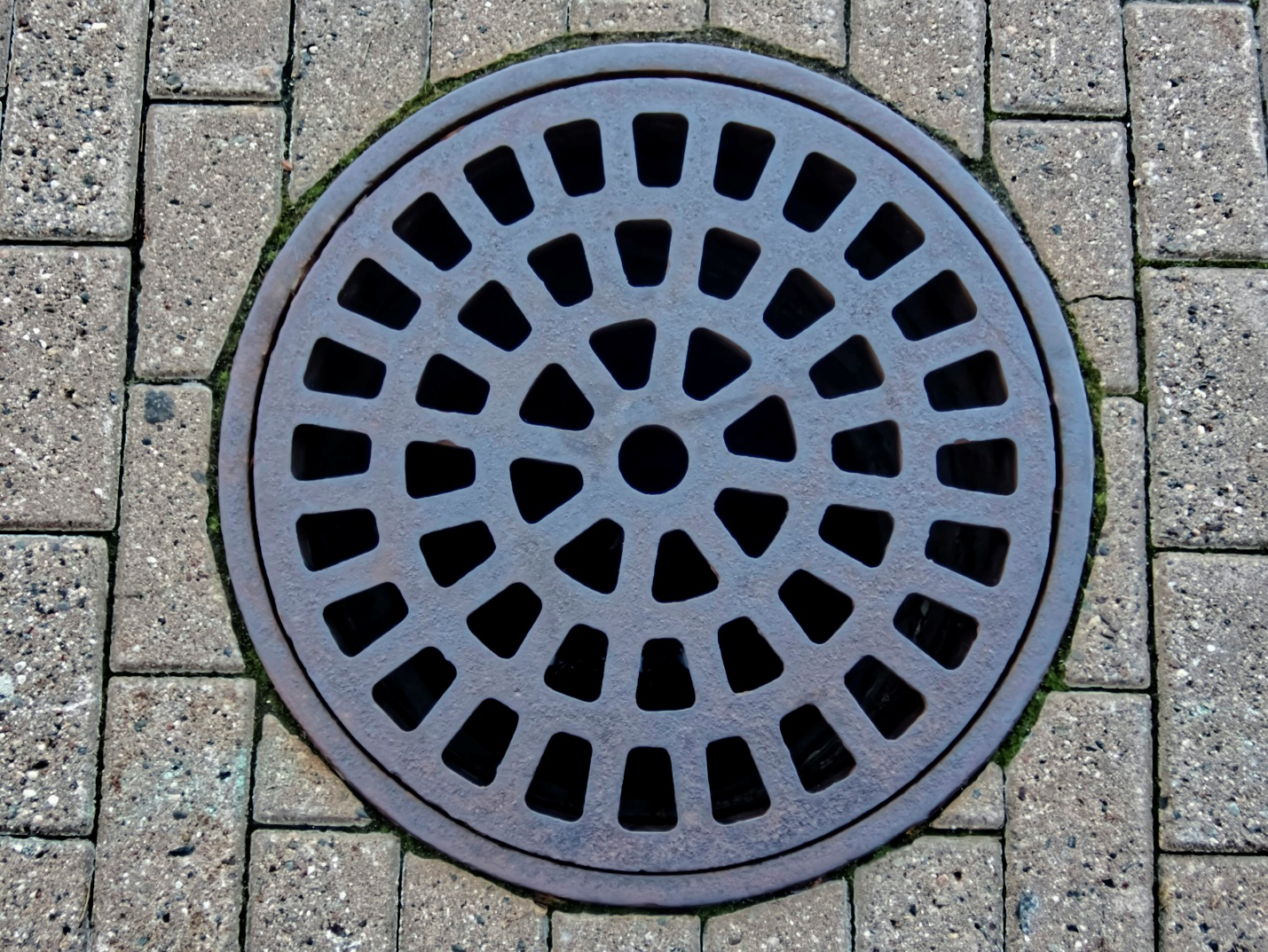 A gray drain in the ground