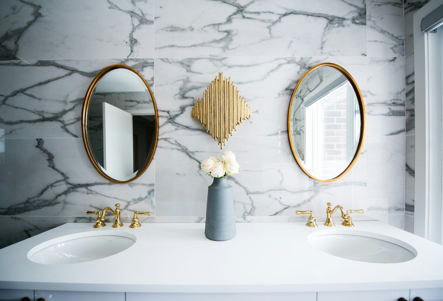 Two sinks with golden faucets