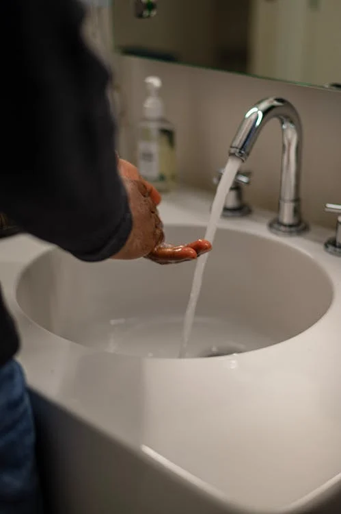 A person washing hands while t