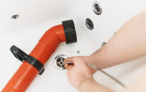 A plumber cleaning a drain