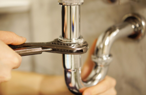 a closeup shot of a plumber at work