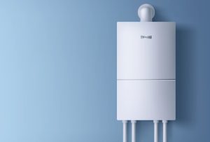 A modern white wall-mounted boiler with visible pipes underneath, attached to a light blue wall. The minimalistic design is clean and sleek, making it a stylish choice for homes in Bristol and Suffolk County, MA.