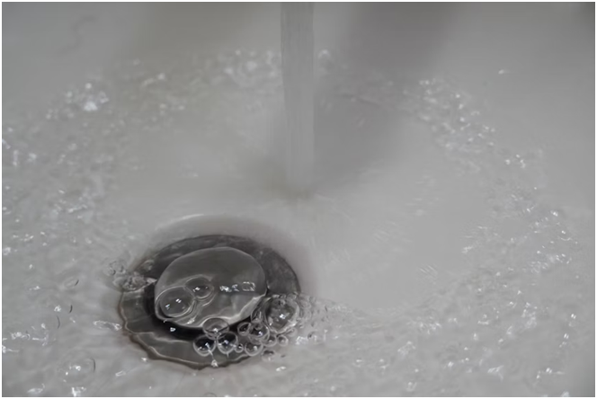 Sink with water bubbling due to stubbornly clogged drains